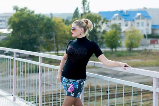 the sexy girl in a miniskirt on the bridge, railway tracks, a subject beautiful women