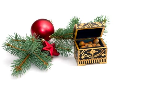 coniferous branch with New Year's scenery and an open casket with nuts, a still life, the subject Christmas and New Year