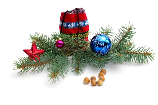 red bag with gifts, a fir-tree branch and hazelnuts, a still life, the subject Christmas and New Year