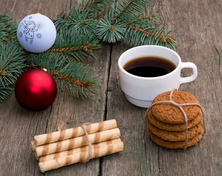 coffee, two linking of cookies and a coniferous branch with scenery, the subject Christmas and New Year