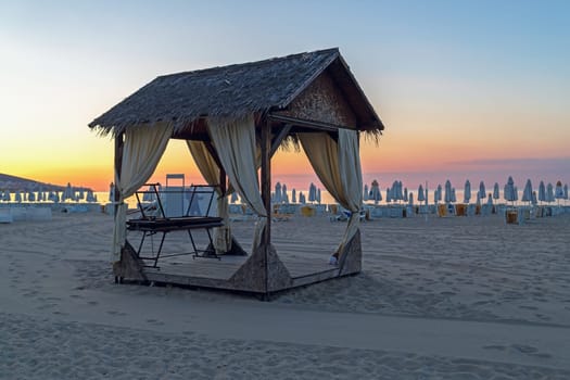 Massage canopy on a sandy beach in the early morning. Shallow depth of field. Focus on foreground.