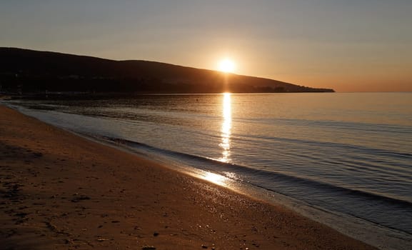Sunrise on the sea from the mountain. Sun reflection in sea. Horizontal shot.