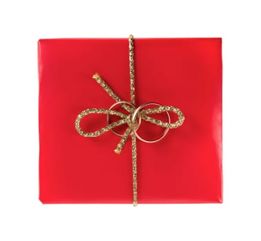 Red gift box with wedding rings on a white background. Isolated with clipping path. Top view.