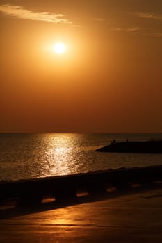 Orange sunrise over the sea. Vertical shot.