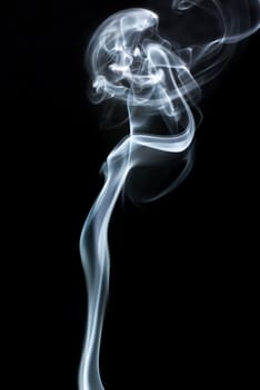 Abstract curls of smoke on black background. Studio shot.