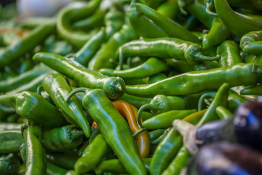 green and few red chili peppers on sale