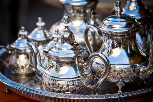 Table setting with silver tableware and dates. Oriental hospitality concept with tea or coffee cups