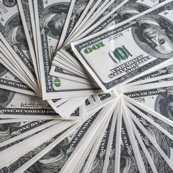 Close-up of a lot of one hundred dollar bills. Much money. Many hundred dollar banknotes. Fake money.