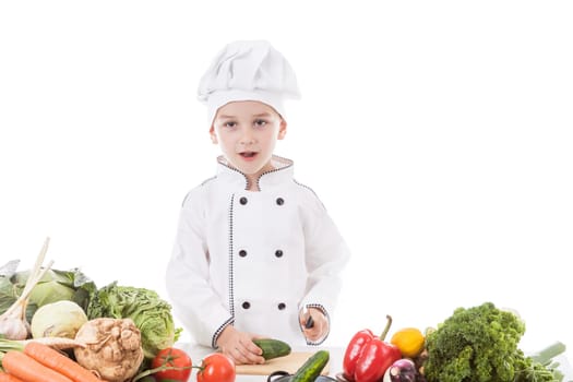 One little boy as chef cook making salad, cooking with vegetables. Isolated on white.