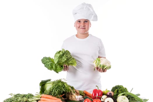 One little boy as chef cook making salad, cooking with vegetables. Isolated on white.