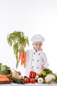 One little boy as chef cook making salad, cooking with vegetables. Isolated on white.