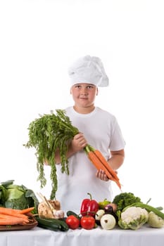 One little boy as chef cook making salad, cooking with vegetables. Isolated on white.