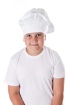 One little boy as chef cook making salad, cooking with vegetables. Isolated on white.