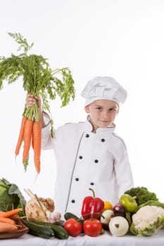 One little boy as chef cook making salad, cooking with vegetables. Isolated on white.