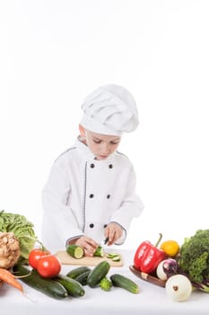 One little boy as chef cook making salad, cooking with vegetables. Isolated on white.