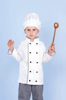 bad young cook with a spoon in his hand