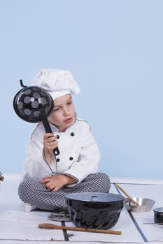 One little boy as chef cook making salad, cooking with vegetables. Isolated on white.