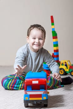 Playing little boy with colored cubes