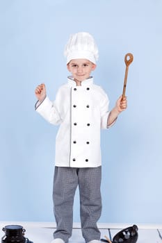 cheerful chef on a blue background with spoon