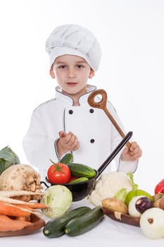 One little boy as chef cook making salad, cooking with vegetables. Isolated on white.