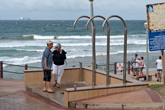 DURBAN, SOUTH AFRICA - JULY 09, 2016: Locals and tourists at Bronze Beach on the Umhlanga Rocks promenade