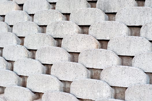 Close up patterns and textures of curved interlocking concrete retaining wall bricks