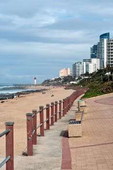 DURBAN, SOUTH AFRICA - JULY 09, 2016: Locals and tourists on the beach near the Millennium Pier and lighthouse in Umhlanga Rocks