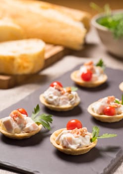 canapes, appetizer with creamy Chicken salad served on a slate plate