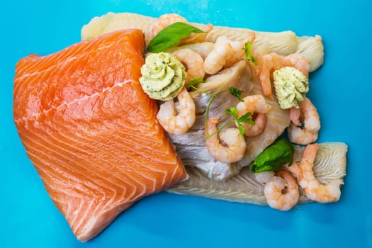 Various raw fish species as fillet such as salmon,cod and shrimp..