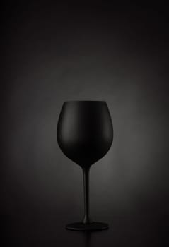 Black glass of wine on black background