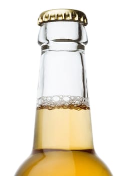 Beer bottle close up isolated on white with a bit of froth and golden cap