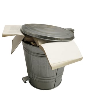 Open books thrown in a metallic trash can isolated on white background