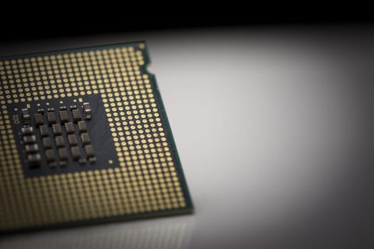 Macro shot of microprocessor with shallow depth of field on grey gradient