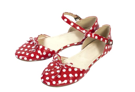 Horizontal side view of red sandals with white dots isolated on white background