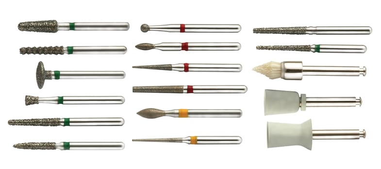 Complete set of chrome dentist drills, viewed from the top isolated on white background