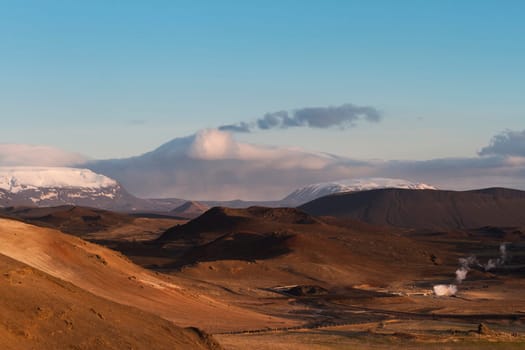 Horizontal panorama of the valley and the mountains covered in snow next to the Myvatn hot springs in Iceland