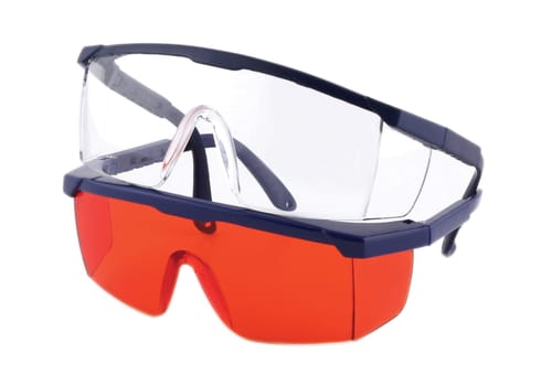 Horizontal side view of two pairs of protective medical eyewear isolated on white background