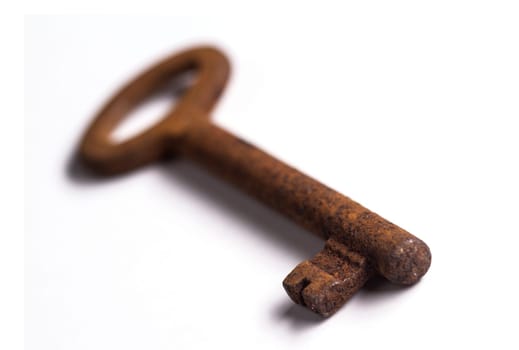 Old rusty key isolated on white background with shallow depth of field