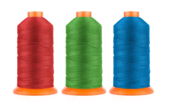 Set of sewing threads in red, blue and green colors isolated on white background