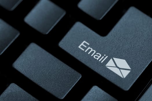 Close up of black buttons on a keyboard with the word email and an icon on one of them