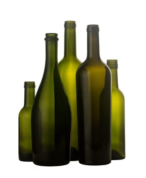 Vertical front view of a group of empty wine bottles of different sizes, shapes and colorisolated on white background.