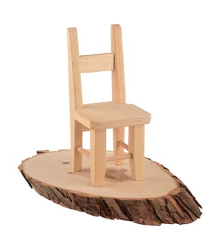 Wooden chair sitting on a slice of wood isolated on white background