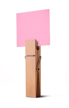 wooden peg holding a white note isolated on white background