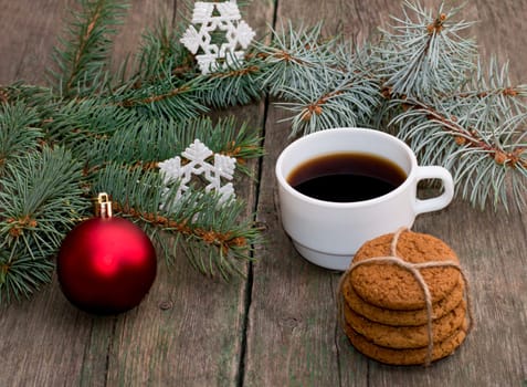 the fir-tree branches decorated with an ornament, coffee baking and snowflakes, a subject holidays Christmas and New Year