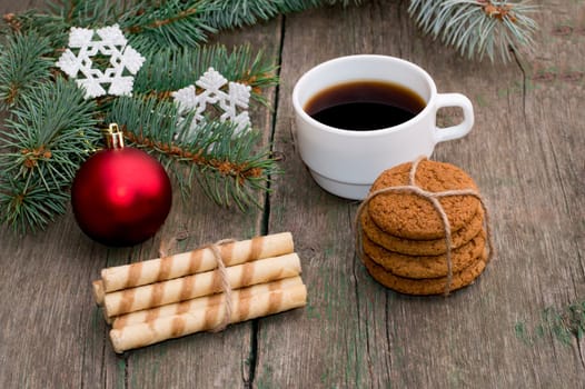 coniferous branch, two linking of cookies and coffee, still life subject Christmas and New Year