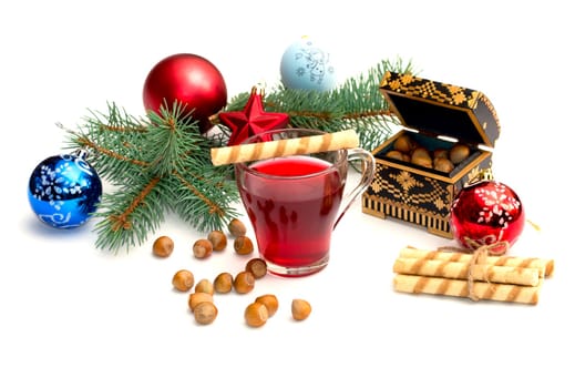 nutlets, tea and coniferous branch with Christmas tree decorations, a still life, the subject Christmas and New Year