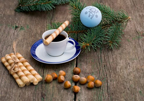 coniferous branch, coffee, linking of cookies and nutlets, still life subject Christmas and New Year