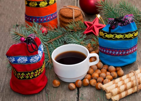 three gift bags, fir-tree branch, coffee and sweets, subject Christmas and New Year