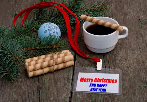 fir-tree branch with Christmas tree decorations, coffee and a label with an inscription Christmas, a subject holidays Christmas and New year
