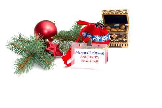 the plate with an inscription Christmas, nutlets and a coniferous branch, a still life, the subject Christmas and New Year